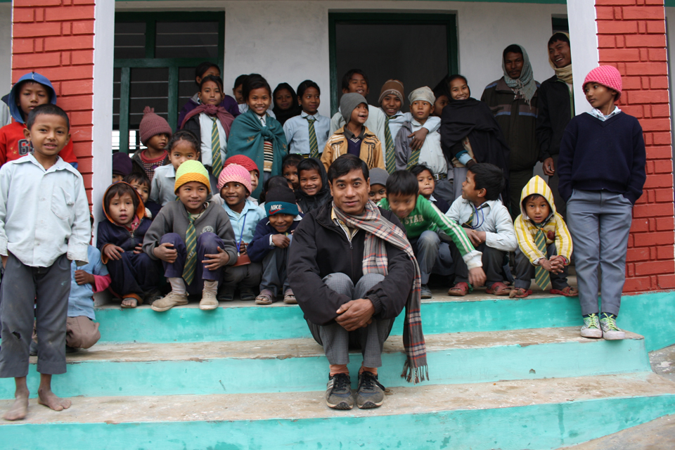 Pupils at the Manakamana Primary School in Kailali pose in front of their new school building with their Headmaster. Picture: Robert Stansfield/DFID