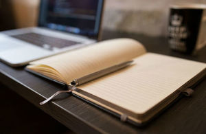 Image of book and laptop