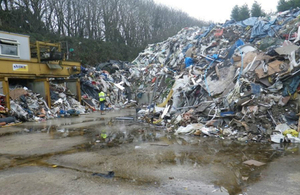 A tall pile of waste stored at the waste transfer station