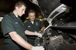 Apprentice NHS mechanic examines an ambulance engine