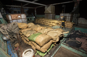 Parcels of seized narcotics lay on the deck of the smuggling vessel.