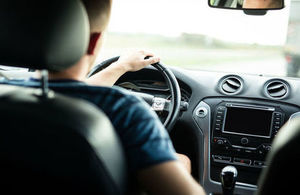 Driver in car taken from the backseat of the vehicle