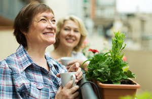 Older woman drinking tea on her balcony