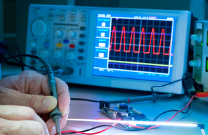 Photograph of a person using electronic test equipment