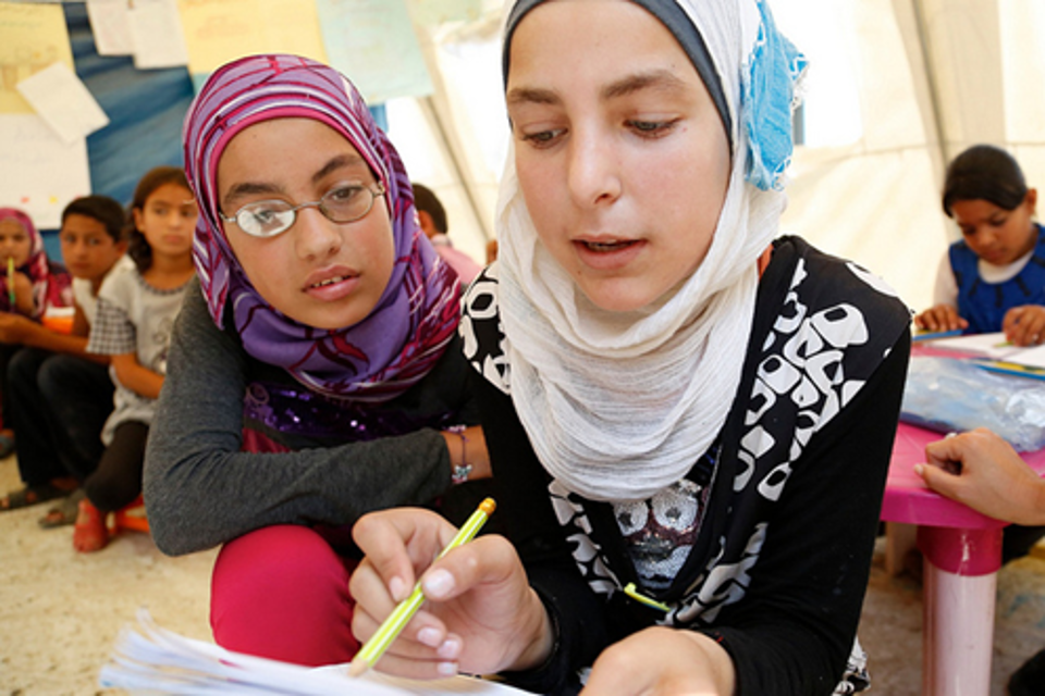 Two children tackle a maths question at a temporary school in nothern Lebanon, set up by UNICEF and Lebanese NGO Beyond Association, woth help of UK aid. Russell Watkins/DFID