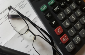 calculator, glasses and bank statement