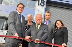 Bob Neill cutting a ribbon