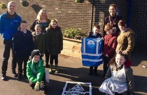 Image shows pupils, NWL and EA putting the Rainworks product on the pavement