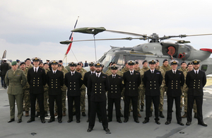 847 Naval Air Squadron stand to attention next to one of two Wildcat helicopters. They have deployed for five months with the Jeanne D'Arc. Crown Copyright.