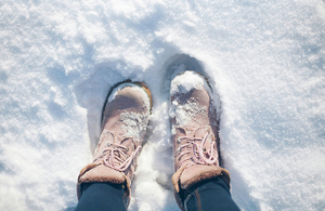 Image of boots in the snow.