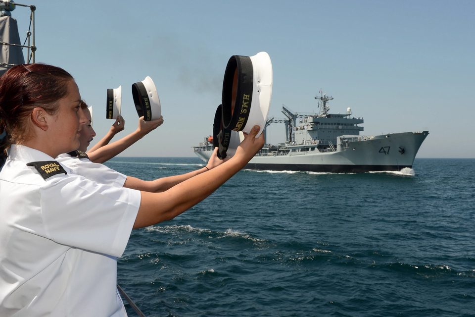 Members of HMS Northumberland's ship's company salute Pakistan Navy ship