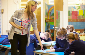 Teacher assisting pupils in class