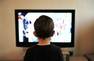 A young boy watching television.