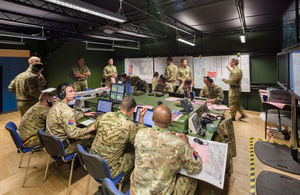 A room that shows many service personnel at work in Joint Battlespace Management.