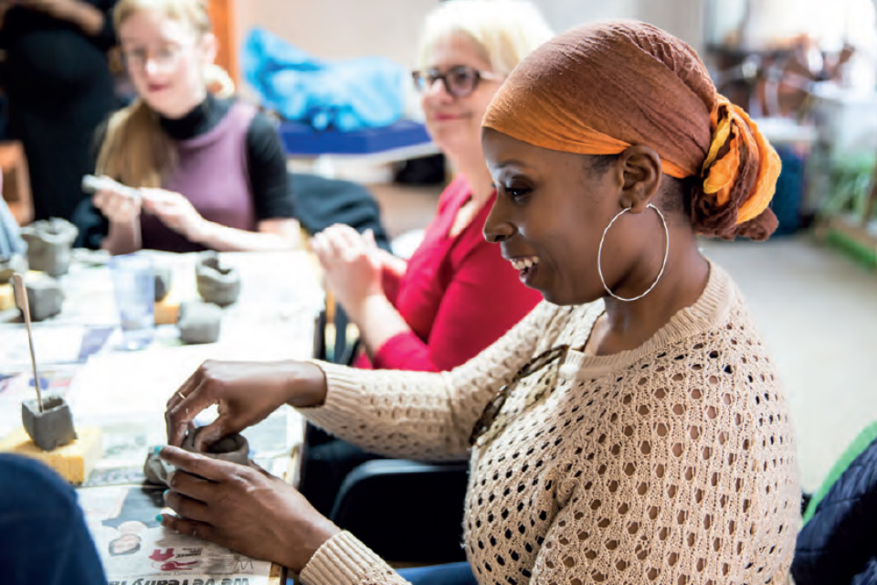A group of women making clay sculptures at a Hey Clay event.