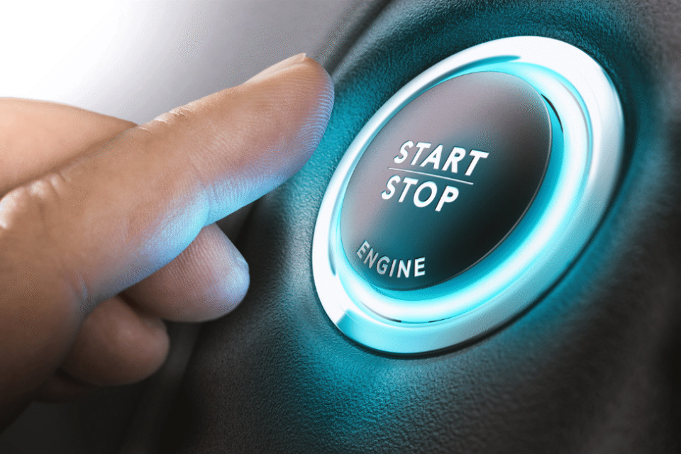 Finger about to press an engine start button (credit: Olivier le Moal/Shutterstock - ID549305095).