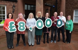 LLWR employees hold up figures to highlight £8,000 charity donation