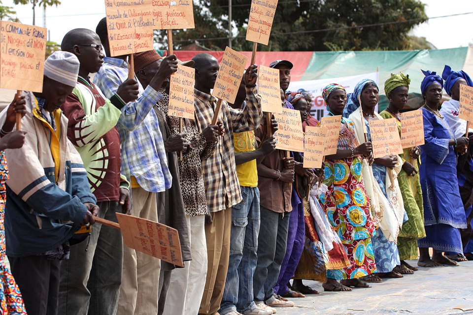 A group of men and women holding up signs. Picture: Tostan International