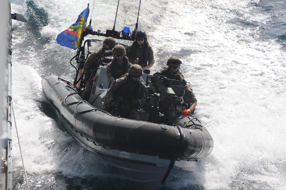 A boarding team from HMS Northumberland speeds away