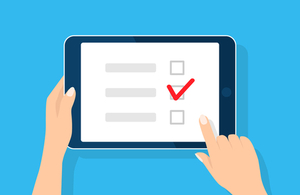 Image of iPad with hand completing survey.