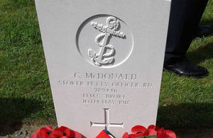 Wreaths adorn the newly marked headstone for PO McDonald, Crown Copyright, All rights reserved