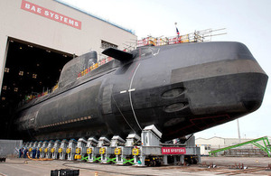 Britain's third Astute Class nuclear submarine, Artful, being lowered into the water at Barrow-in-Furness. Crown copyright.