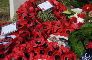 Wreaths lay below the newly engraved headstone, Crown Copyright, All rights reserved