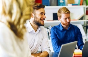 Cheerful coworkers in a meeting via nd3000 Shutterstock