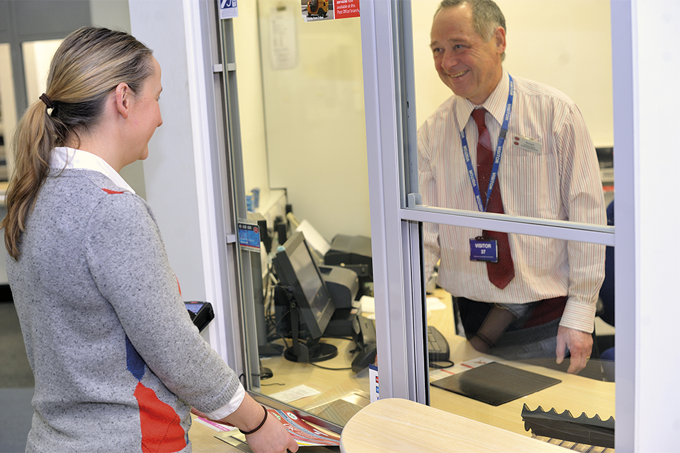 Image of person being served at Post Office counter