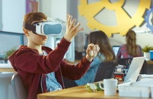 A young boy wears a virtual reality headset