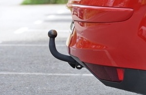 image of a red car with a towbar attached