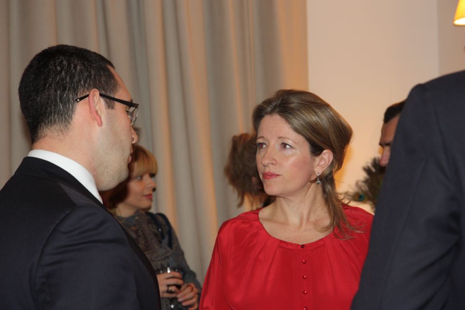 A female and a male guest at the reception talking.