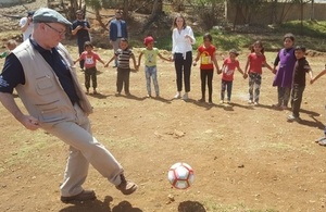 Minister Burt playing football with Syrian refugee children
