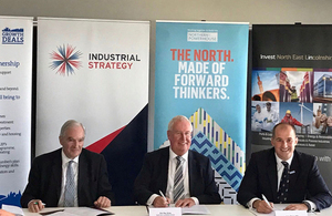 Lord Henley, Councillor Ray Oxby, and Jake Berry signing the Greater Grimsby Town Deal.