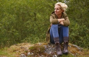 A woman in the countryside via Ben Queenborough at Shutterstock