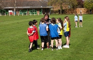 Primary school children doing PE outside