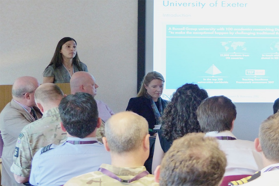 Woman standing behind podium, delivering a presentation.