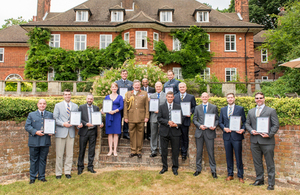 Members of the JFC staff pose for a photo with General Sir Chris Deverell, after recieving their commendations