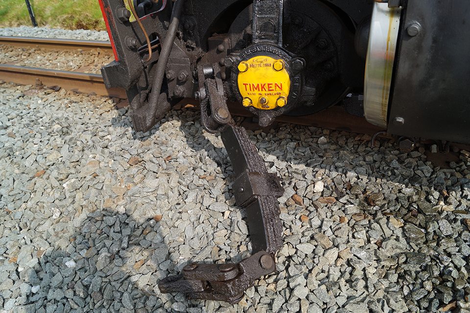 The derailed leading wheelset. The leaf spring suspension and associated components had become disarranged as a consequence of the failure (photograph courtesy of Ffestiniog and Welsh Highland Railways).