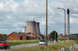 Residential area with colling towers in background