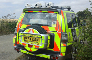 Cuddly cow toys on the roof of a traffic officer vehicle