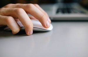 Hand on computer mouse.