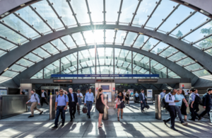 A photograph of people entering and leaving Canary Wharf tube station.