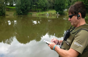 Environment Agency officers checking fishing licences