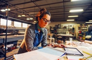 Engineer reviews plans in her workshop via Dusan Petkovic at Shutterstock