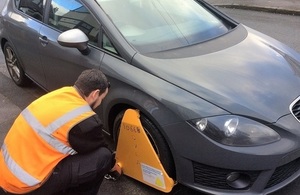 Image of a man clamping a car