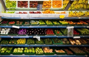 Shop shelves stocked with fruit and vegetables