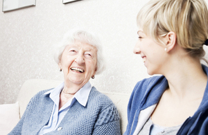 Elderly woman talking to younger carer