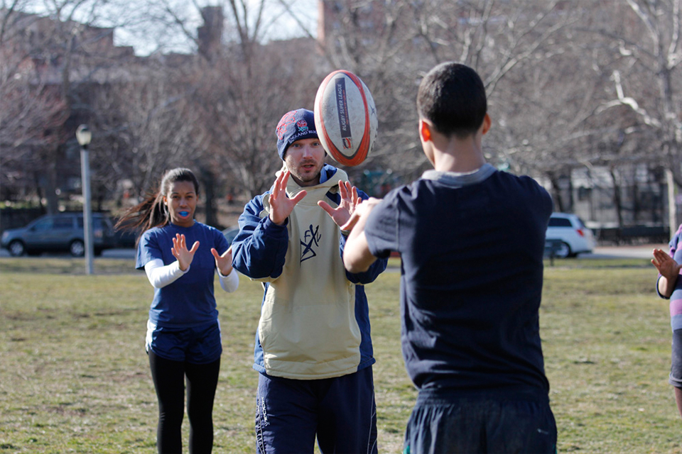 The crew of the HMS Edinburgh volunteer with Play Rugby USA.