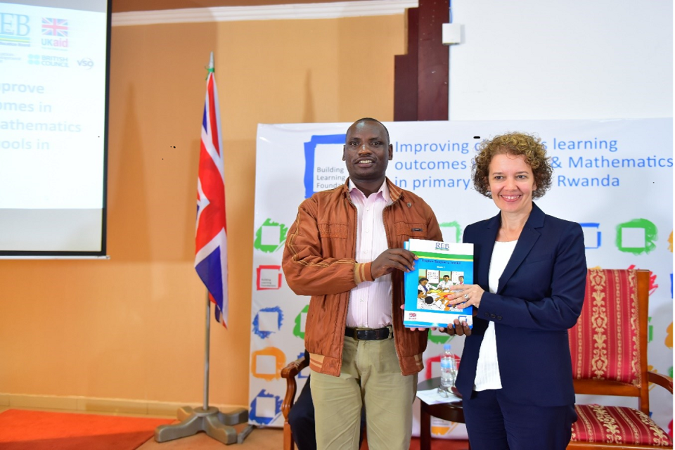 Jo Lomas, British High Commissioner to Rwanda, presents an English toolkit to the head teacher of Kagugu Primary school at the BLF launch